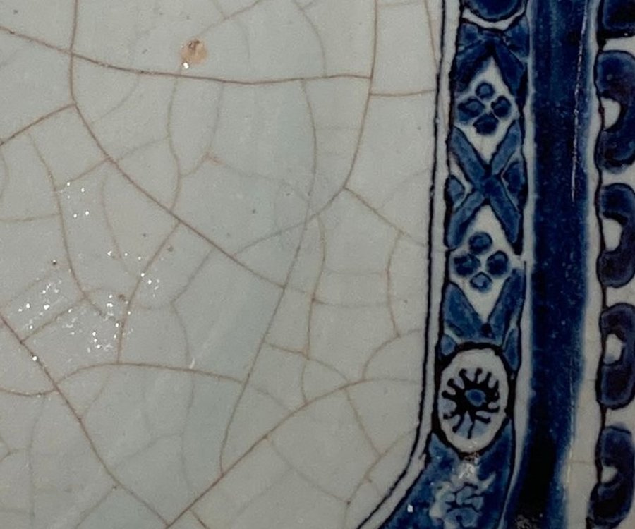 Assiette en faïence craquelée à décor bleu, après intervention discrète